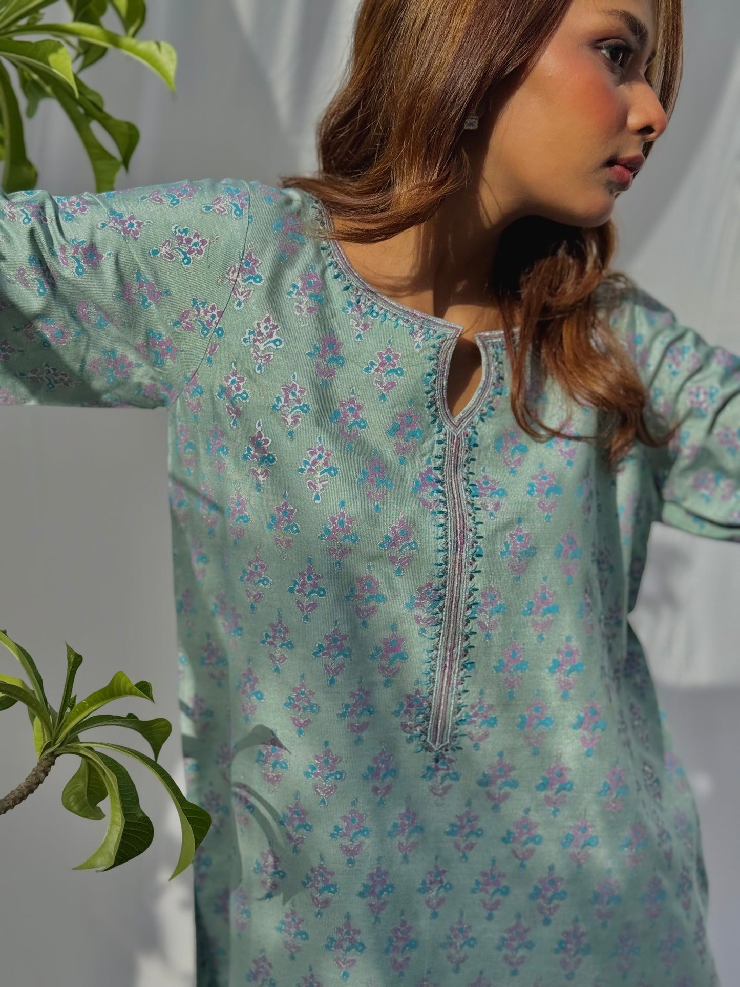 Light green floral patterned top with a neutral background